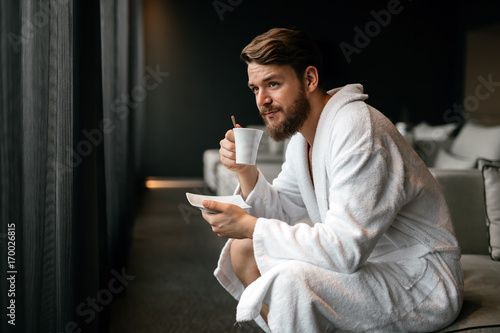 Handsome man drinking tea photo