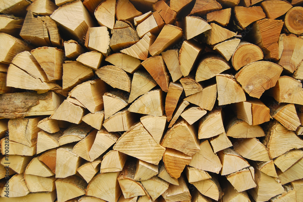 Firewood stacked for winter - firewood background Firewood stacked for winter - firewood background