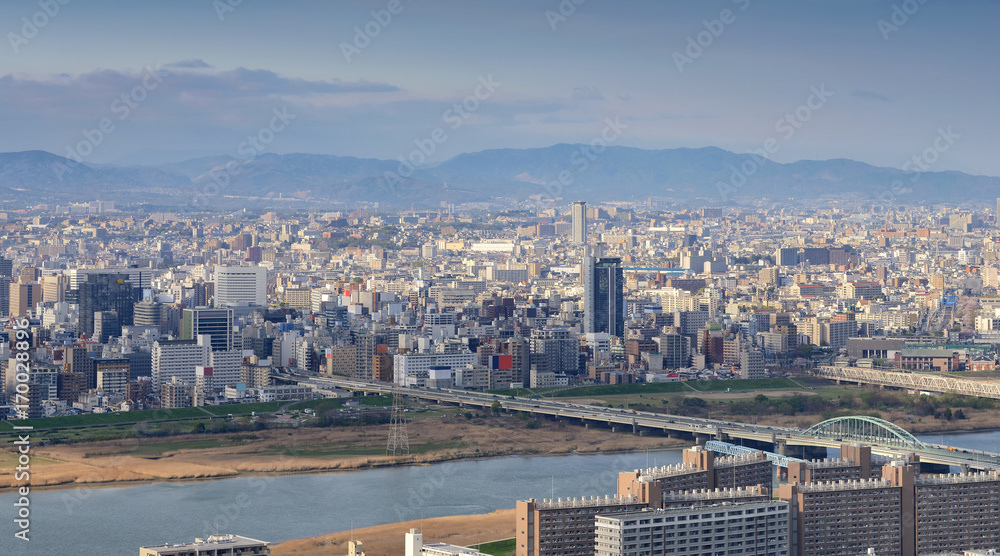 High angle panoramic view of Osaka city with Yodo river at sunset time. Japan