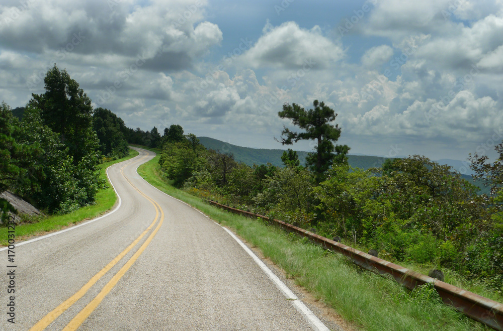 Curving roads in Oklahoma, southeastern region in the Ouachita Mountains, scenic vistas along the byway that follows the ridge of mountains from west to east. Curving roads in Oklahoma, southeastern region in the Ouachita Mountains, scenic vistas along the byway that follows the ridge of mountains from west to east.