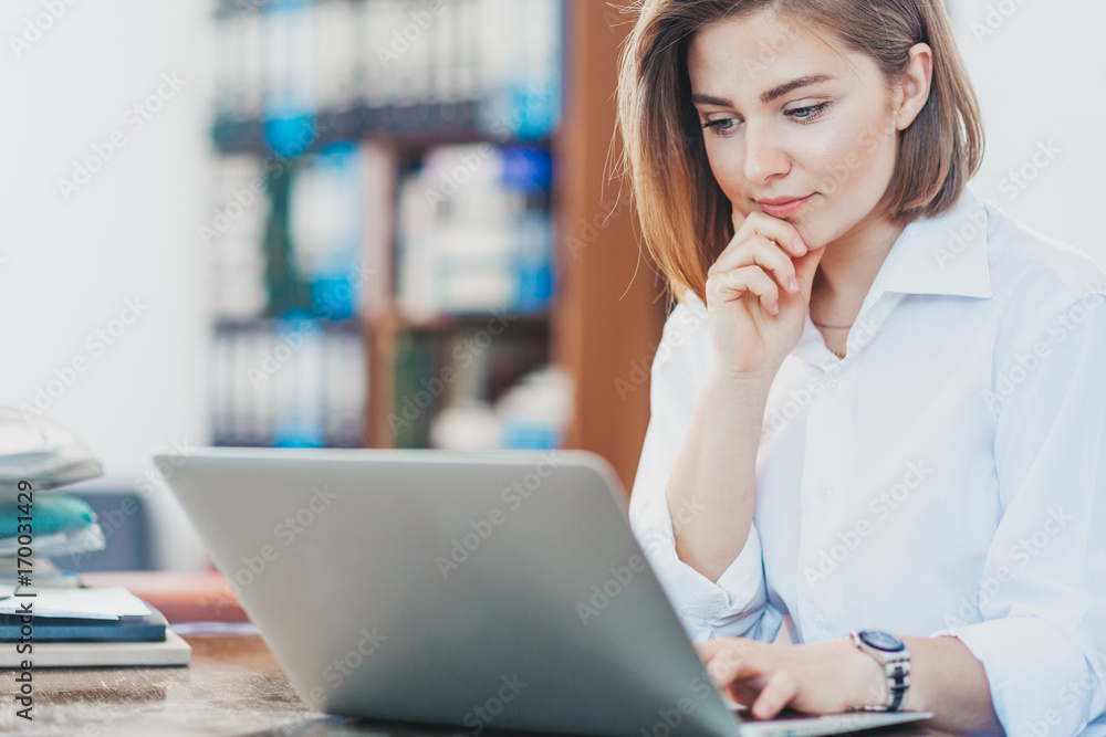 Young woman reading from laptop Young woman reading from laptop