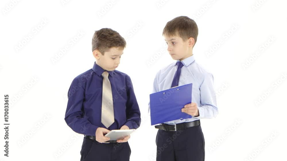Two young businessmen boys stipulate reports and graphs. White studio Two young businessmen boys stipulate reports and graphs. White studio
