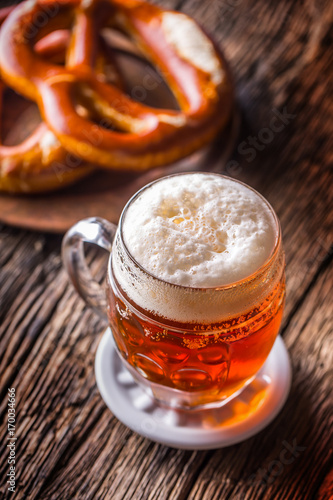 Beer and Oktoberfest. Draft beer pretzel and blue checkered tablecloth as traditional products for bavarian festival oktoberfest