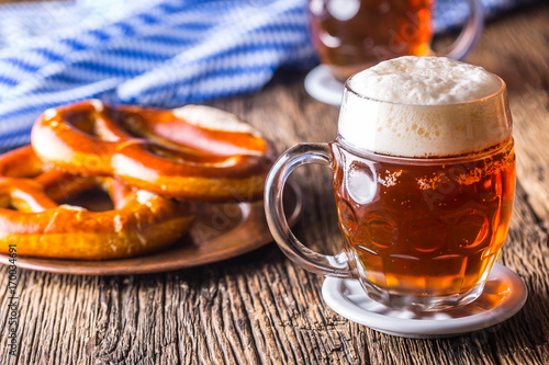 Beer and Oktoberfest. Draft beer pretzel and blue checkered tablecloth as traditional products for bavarian festival oktoberfest photo