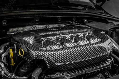 Close up detail of car engine, carbon fiber part