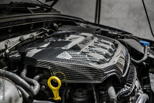 Close up detail of car engine, carbon fiber part