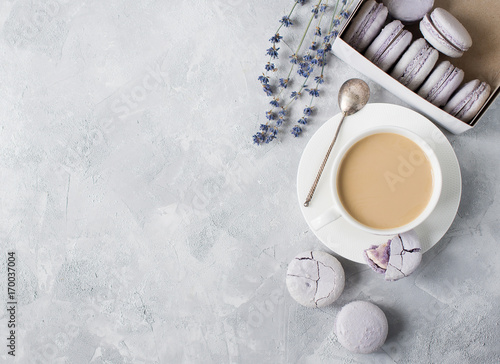 Macarons in box and on table with cup of coffee and lavender.