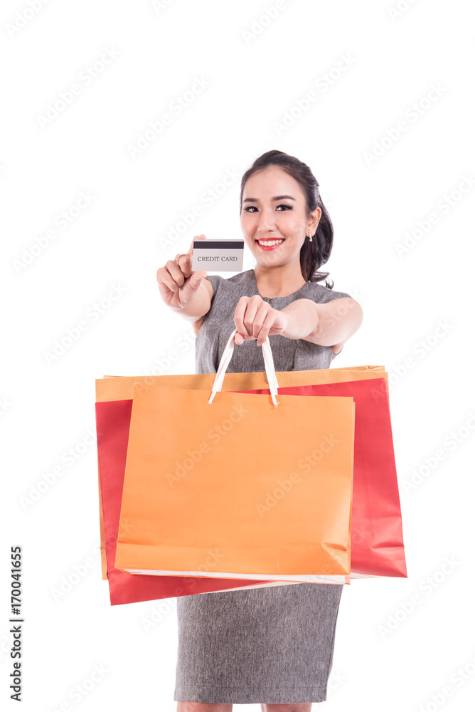 Happy smart business woman show credit card holding colorful shopping bags. isolated on white ,copy space Happy smart business woman show credit card holding colorful shopping bags. isolated on white ,copy space