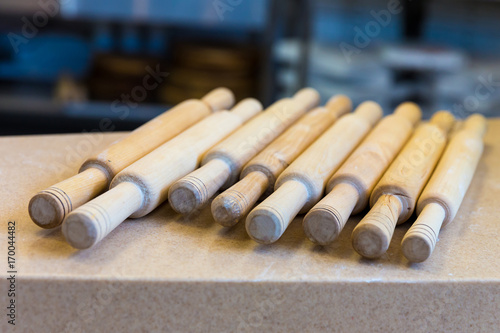 Wooden rolling pin on the table closeup