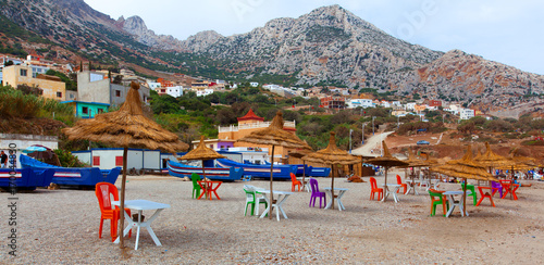 Panorama of Beautiful coastline in morocco. belyouneche. Chairs And Umbrella In moroccan Beach. colorful chairs under umbrella at beach