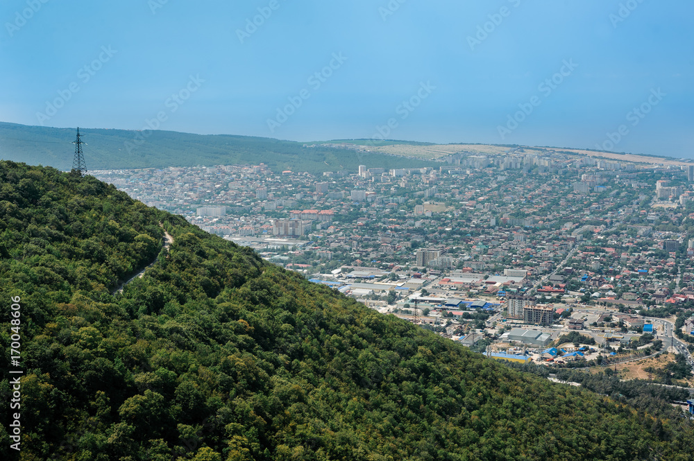 Aerial view of the city at the foot of the green hill. Black Sea, Russia