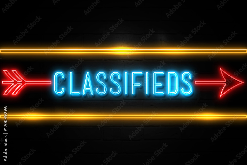 Classifieds  - fluorescent Neon Sign on brickwall Front view