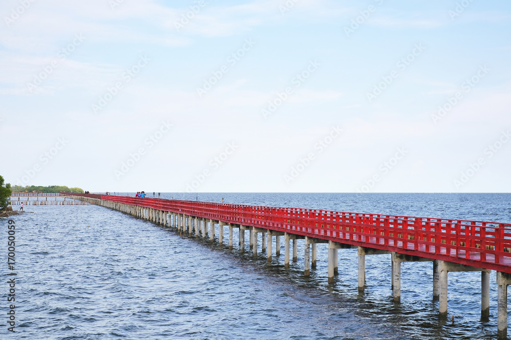 long red bridge beside water pier