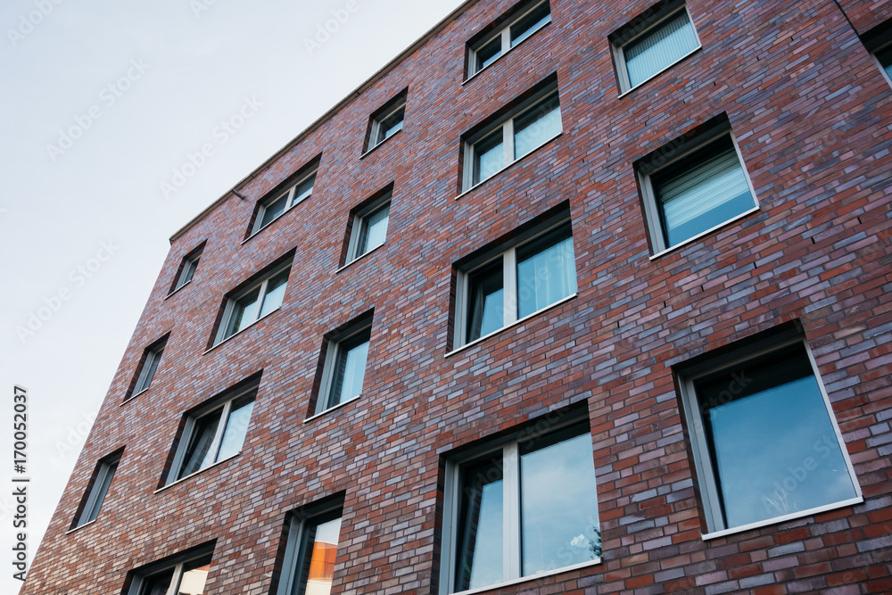 brick facade apartment building in low angle view brick facade apartment building in low angle view