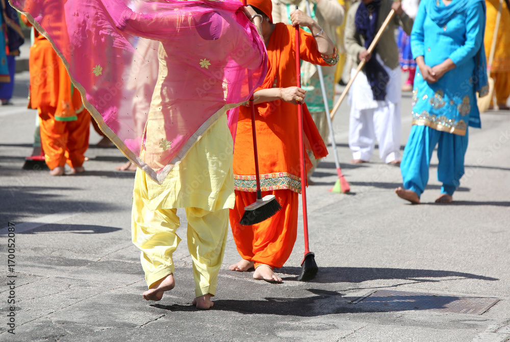 Sikh religion women during the ceremony  while sweeping the stre