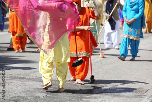 Sikh religion women during the ceremony while sweeping the stre
