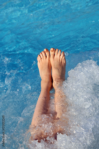 barefoot woman in the pool of the spa during a session of massag