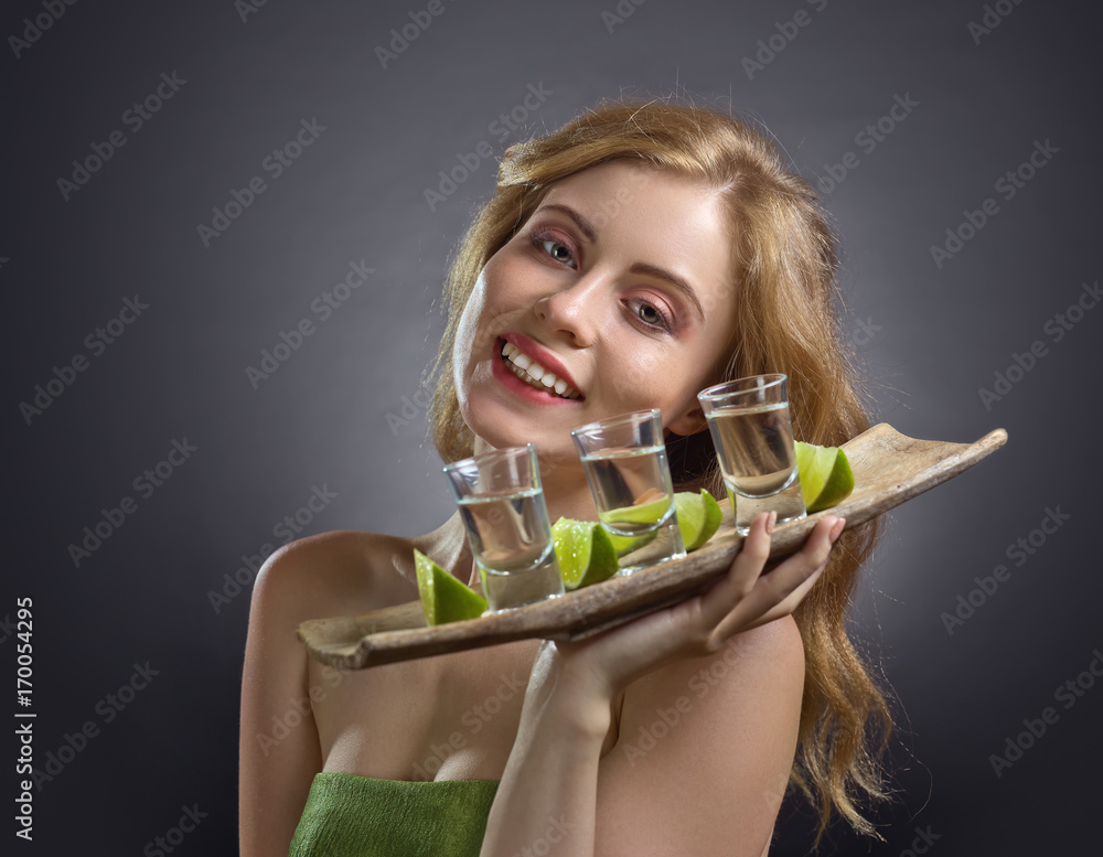 Blonde woman with glasses of tequila . Blonde woman with glasses of tequila .