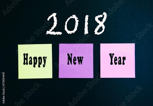 Happy New Year 2018 on sticky multi colored paper on black background