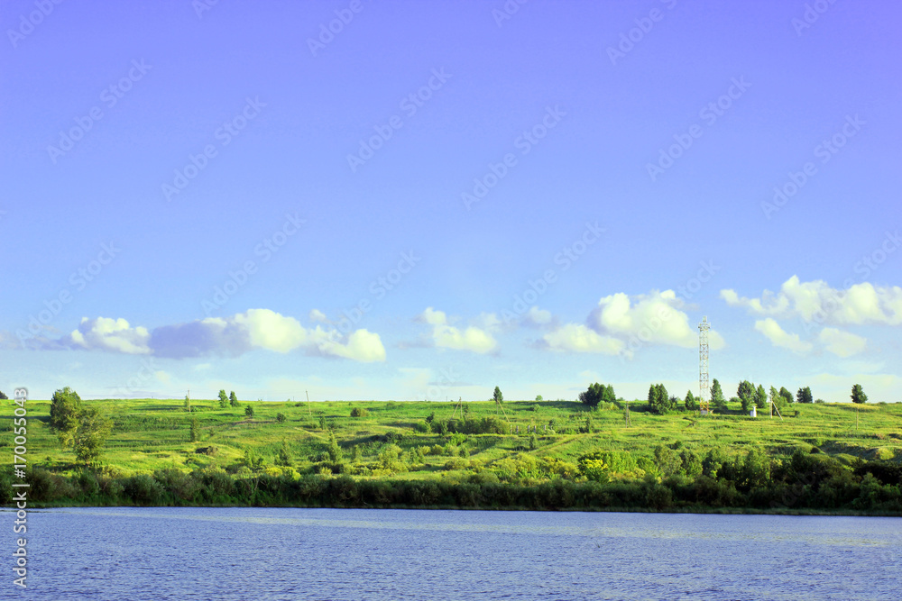The river, shore and sky in summer day