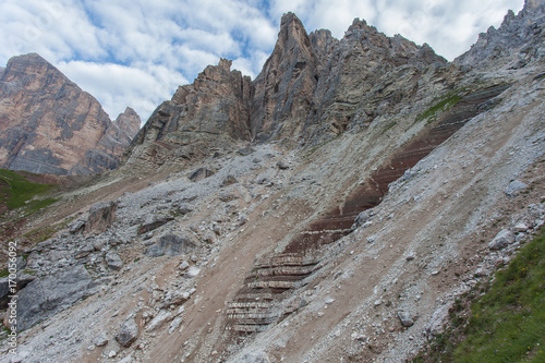 Red rocks, blocks and debris at the fotto of dolomitic wall, Cortina d'Ampezzo, Dolomites, Italy