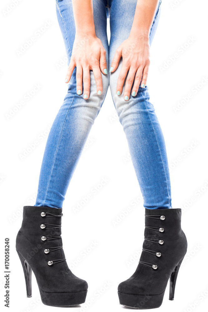 female hands and legs in jeans and high heels female hands and legs in jeans and high heels
