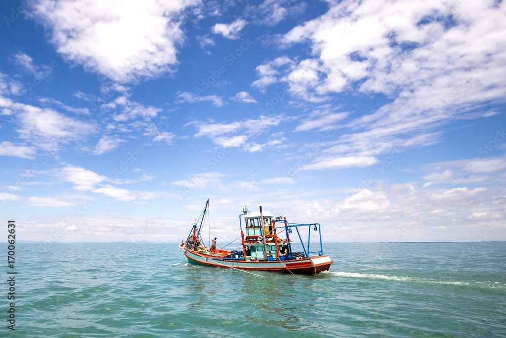 Fishing boat on a sea and deep bluesky background,Thailand
