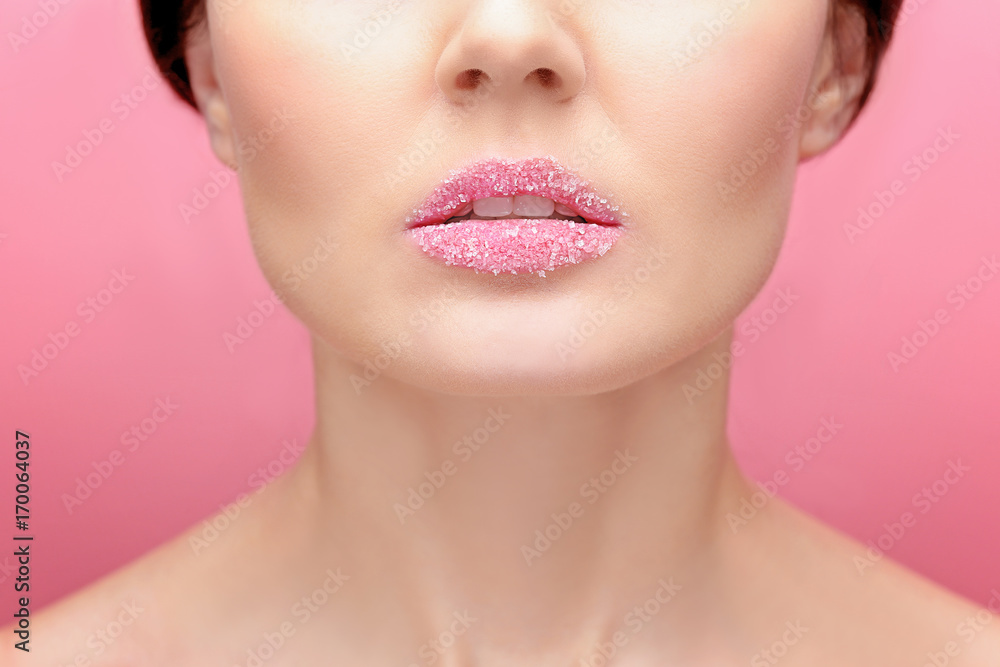 Obraz premium Beautiful young woman with sugary lips on color background