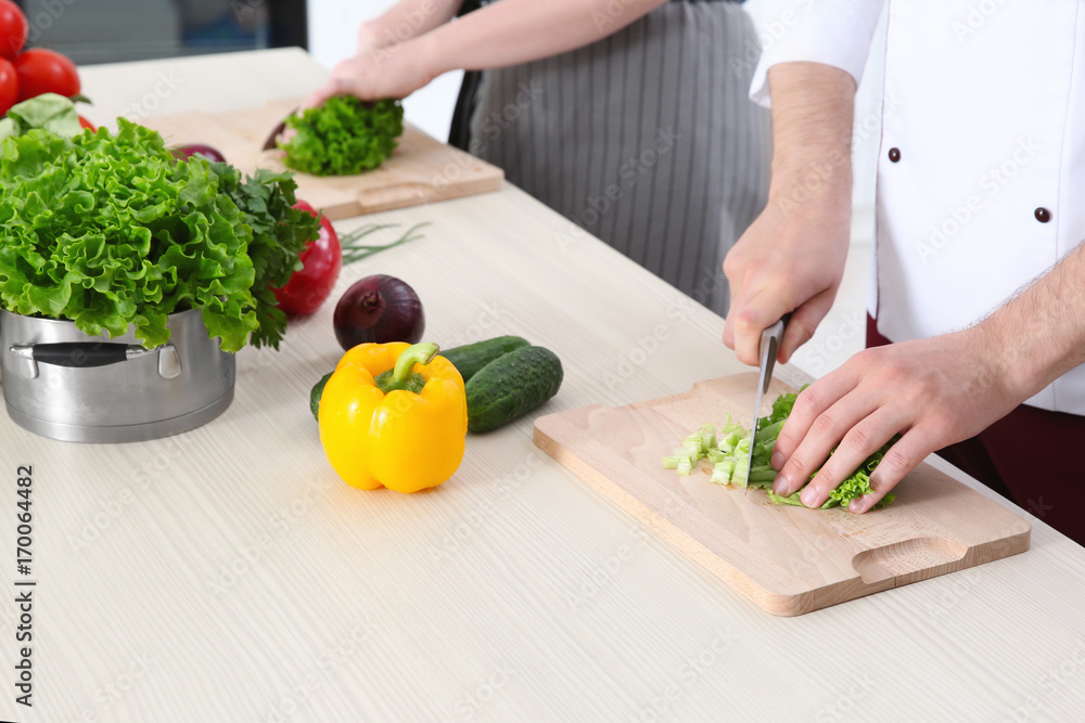 Chef giving cooking classes in kitchen Chef giving cooking classes in kitchen