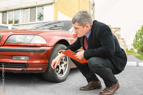 Insurance man checking broken car after accident © Africa Studio