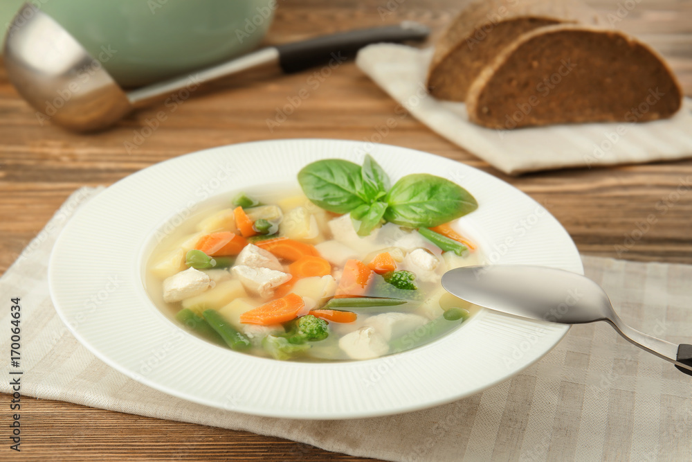 Plate with delicious turkey soup on table Plate with delicious turkey soup on table