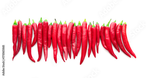 Horizontal row of red chili peppers isolated on white