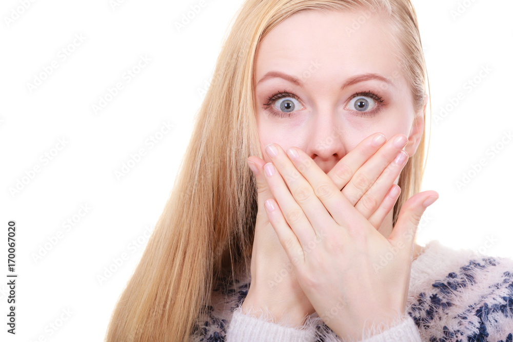 Shocked young woman covering mouth with hand Shocked young woman covering mouth with hand