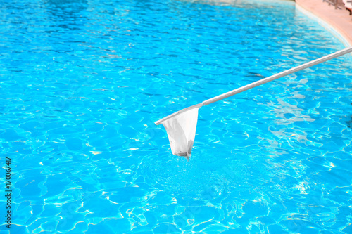 Cleaning swimming pool with net