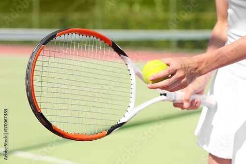 Young woman playing tennis on court © Africa Studio