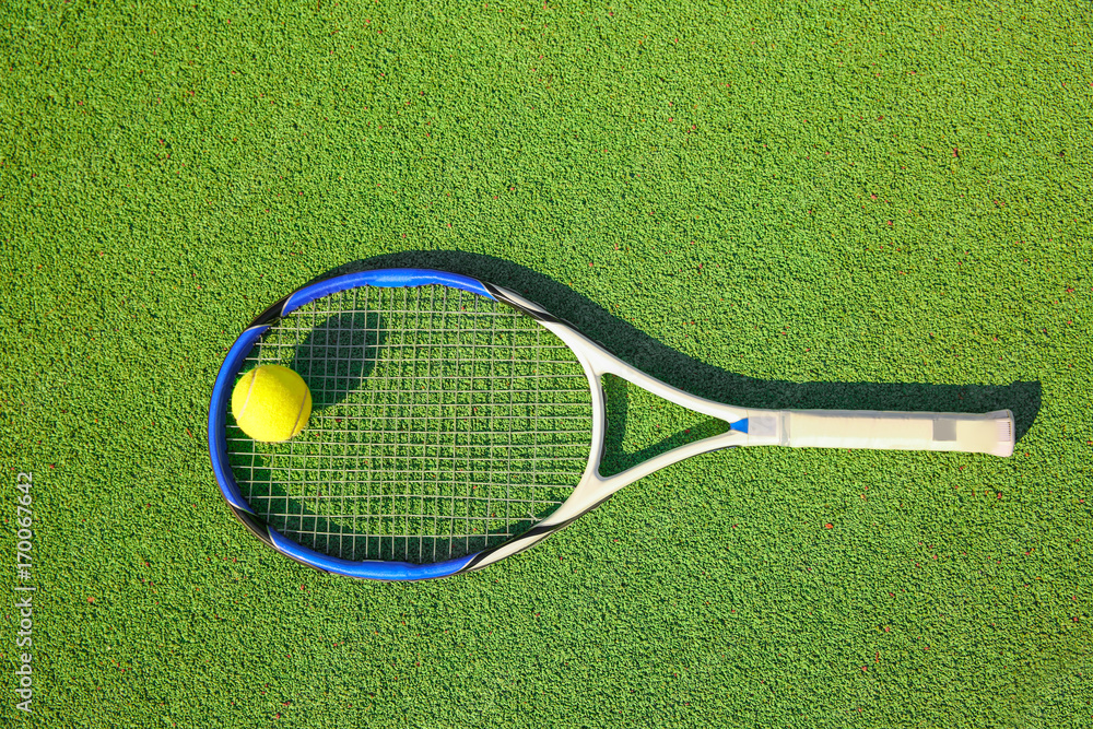 Tennis ball and racket on court