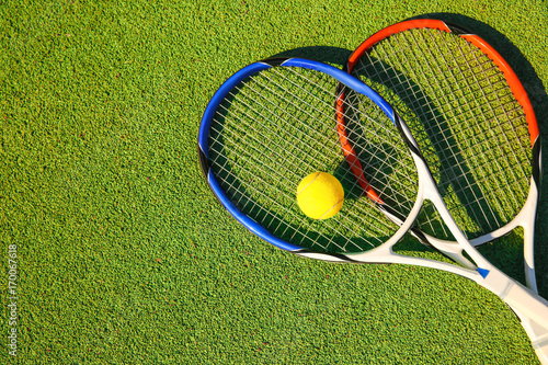 Tennis ball and rackets on court © Africa Studio
