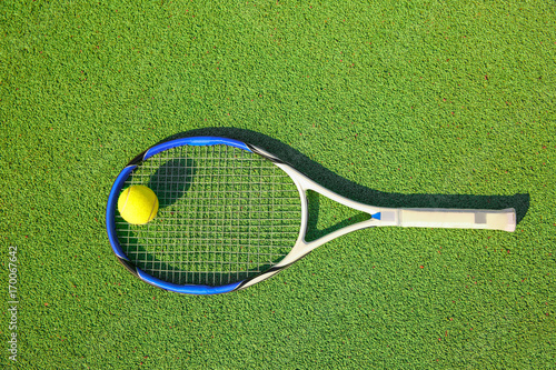 Tennis ball and racket on court