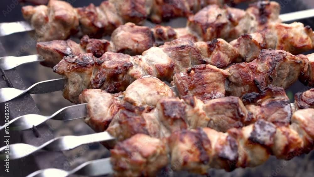 Grilling pork kebab on skewers at bbq, cooking process Grilling pork kebab on skewers at bbq, cooking process