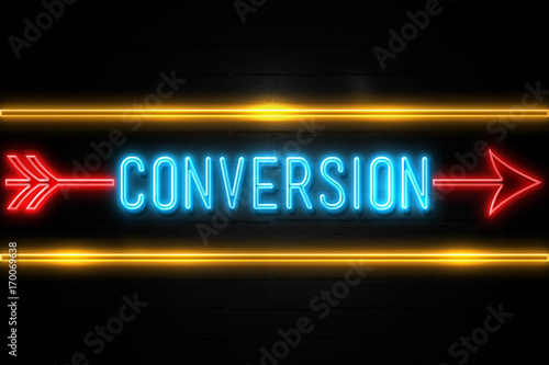 Conversion  - fluorescent Neon Sign on brickwall Front view photo