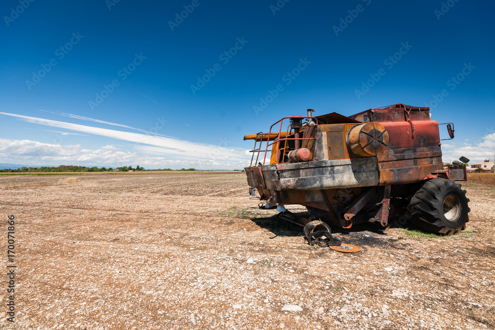 Fototapeta premium Accidental and burned tractor for grain processing