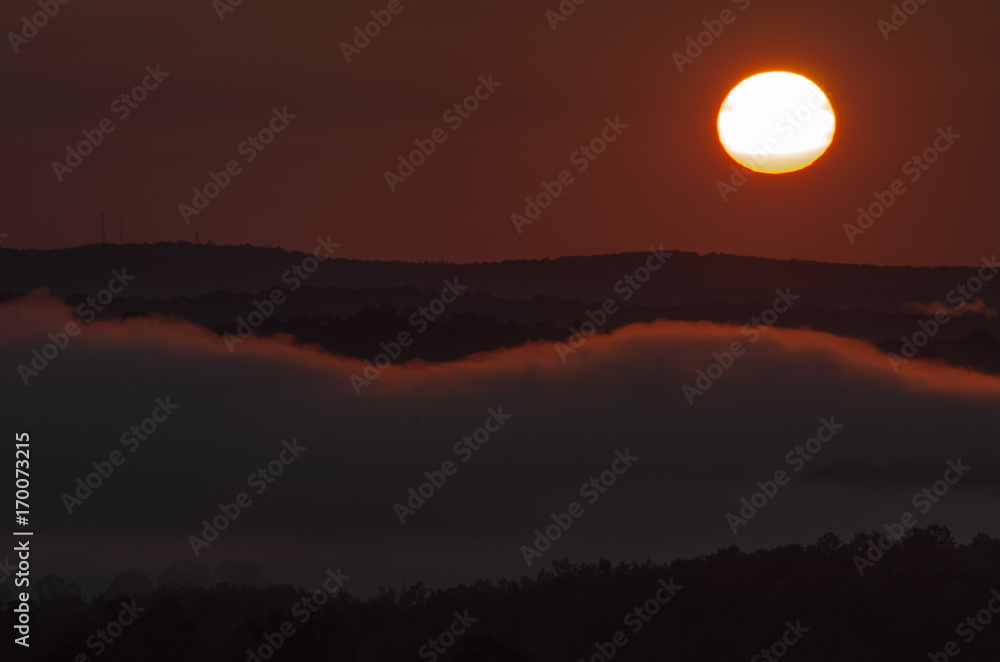 A morning sun over the foggy valleys near Heflin, Alabama, USA A morning sun over the foggy valleys near Heflin, Alabama, USA