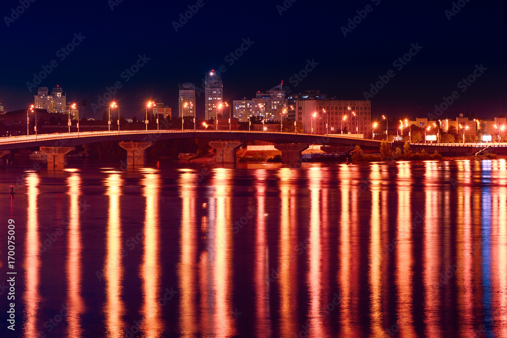Havana bridge in Kiev at night with colorful illumination and reflection in Dnieper river