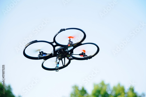 Outdoor flying drone. Quadrocopter in park