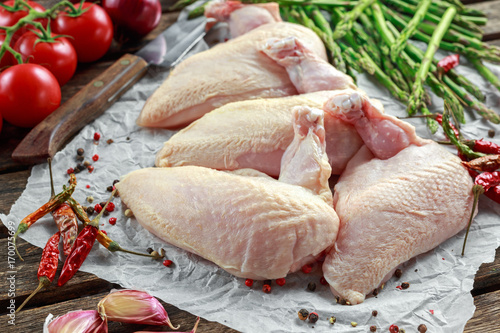 Photos Raw Chicken breast supremes fillets with chilli, pepper corns and thyme