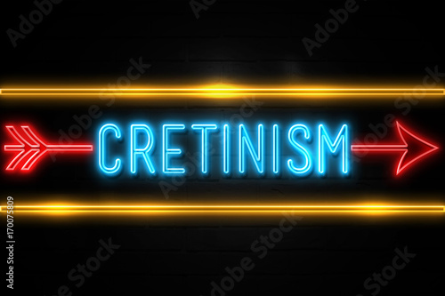 Cretinism  - fluorescent Neon Sign on brickwall Front view photo