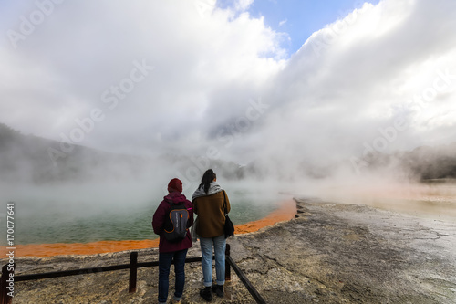 Couple watching geothermal lake.