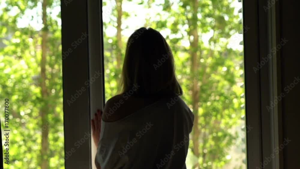 Woman unveil curtains stretching and walking out on terrace
Woman unveil curtains stretching and walking out on terrace
