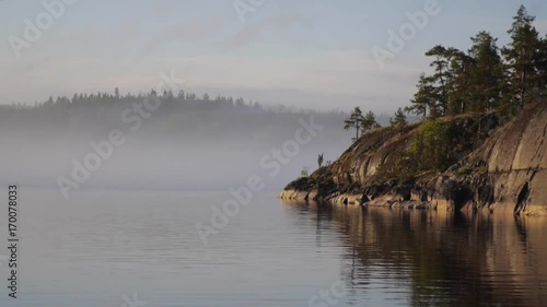 Strong fog on Ladoga lake. Island in Karelia, Russia. Skerries