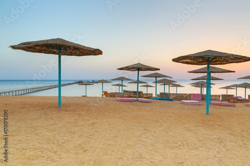 Sunrise under parasols on the beach of Red Sea  Egypt